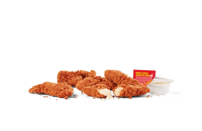 A serving of five crispy spicy chicken strips, arranged with a bite taken out of one to reveal the tender interior. Accompanied by a Honey Garlic Sriracha dipping sauce and a small container of creamy dip on transparent background.