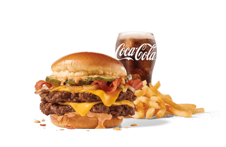 The Bacon Double Smashed Jack Combo featuring two beef patties layered with bacon, cheese, lettuce, and tomato, accompanied by a side of fries and a glass of Coca-Cola, presented on transparent background.