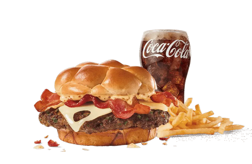A Bacon Swiss Buttery Smashed Jack™ burger loaded with bacon, Swiss cheese, and a special sauce on a buttery bun, served with crispy fries and a cold Coca-Cola, set against transparent background.