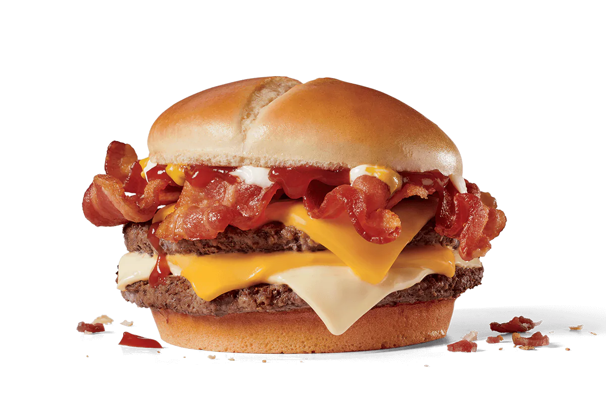 Image of a Bacon Ultimate Cheeseburger featuring two beef patties layered with slices of American cheese, crispy bacon strips, and topped with ketchup and mayonnaise on a soft bun.