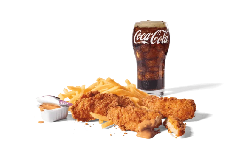 A meal featuring three crispy chicken strips, served with a side of golden fries, dipping sauce, and a refreshing glass of Coca-Cola, all set against a neutral background for an appetizing display.