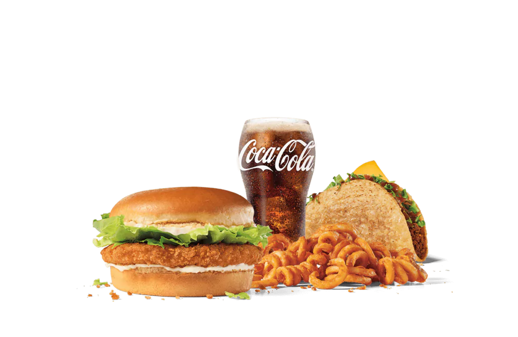 A tantalizing fast food meal featuring a crispy chicken sandwich with lettuce and mayonnaise on a sesame bun, a taco filled with beef and topped with cheese and lettuce, a serving of curly fries, and a glass of Coca-Cola with condensation.
