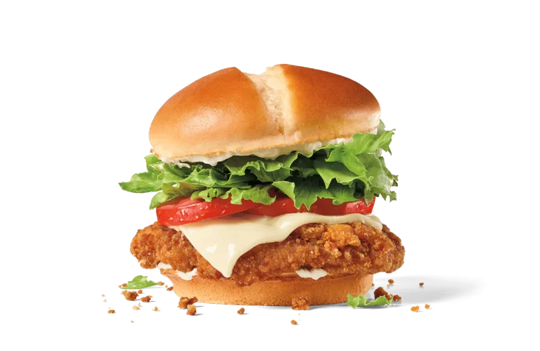 A delectable spicy chicken sandwich featuring a crispy chicken patty topped with a slice of melting cheese, fresh lettuce, and ripe tomato slices, all held together by a toasted golden bun, on a transparent background.