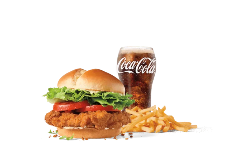 Jack's Spicy Chicken® sandwich offering a succulent spicy chicken patty with crisp lettuce and ripe tomato on a fresh bun, served with a side of golden fries and a cold Coca-Cola, against transparent backdrop.