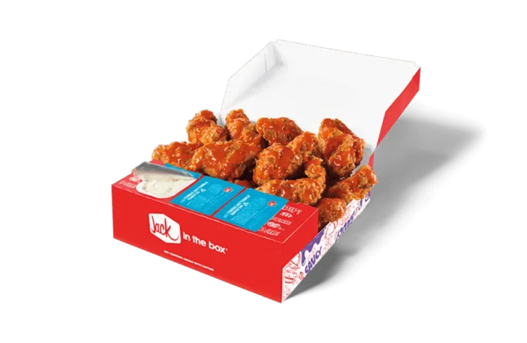 A 12-piece Buffalo Crispy Chicken Wings box from Jack in the Box, showcasing golden-brown crispy wings coated in a vibrant buffalo sauce. The box includes dipping sauce and moist towelette packets, all arranged in a red box featuring the Jack in the Box logo. The open lid displays the wings in a tempting, ready-to-eat presentation.