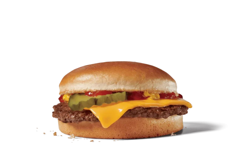 A close-up view of a classic cheeseburger featuring a perfectly toasted bun, a juicy beef patty, melted cheese, ketchup, and pickles. The cheeseburger is showcased against transparent background, highlighting its vibrant colors and delicious layers, making it a mouthwatering choice for any meal.