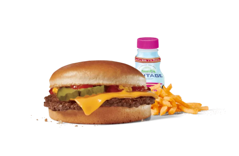 A classic cheeseburger meal featuring a juicy burger topped with melty cheese, ketchup, and pickles, served with a side of crispy golden fries. Accompanied by a bottle of low-fat milk, the meal is presented on transparent background, highlighting the vibrant colors and appealing textures of this quick and tasty dining option.