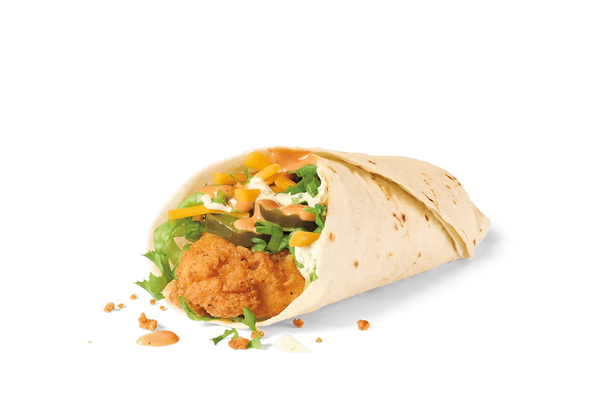 A freshly made wrap featuring a crispy breaded chicken patty, surrounded by shredded lettuce, diced yellow and green bell peppers, and drizzled with a creamy sauce, all encased in a soft flour tortilla. The wrap is partially open, showing its savory contents, with crumbs scattered around on transparent background.