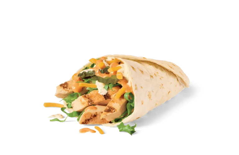 A close-up image of a grilled chicken wrap, sliced open to reveal the filling of diced grilled chicken, jack cheese, fresh lettuce, and a creamy orange sauce, all wrapped in a soft tortilla.