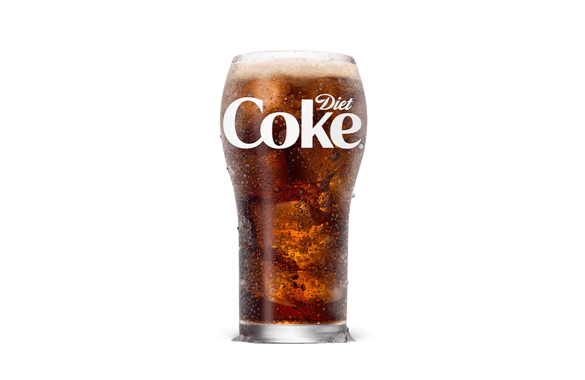 A tall glass of Diet Coke® filled with ice cubes, showcasing the crisp and bubbly dark soda topped with a light foam layer, offering a low-calorie refreshment option.