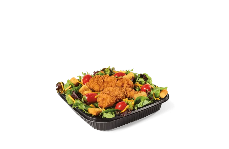 A delicious garden salad topped with crispy fried chicken, fresh tomatoes, and colorful veggies. Served in a black takeout container, this meal combines the crunch of fried chicken with the freshness of greens for a perfect balance of flavors.