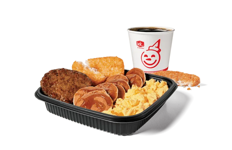 A hearty Jumbo Breakfast Platter from Jack in the Box, featuring scrambled eggs, savory sausage, crispy hash browns, and mini pancakes drenched in syrup, served alongside a hot cup of coffee, set against a transparent background for a satisfying meal.