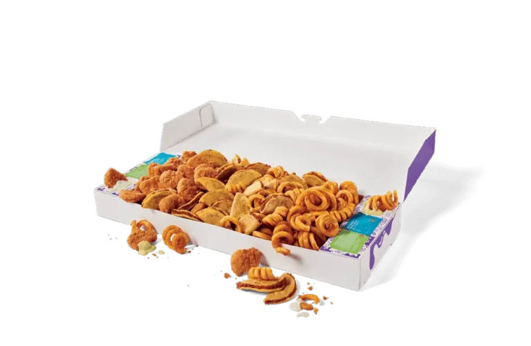 An open Mega Munchies Box from Jack in the Box, filled with a variety of snacks, including golden brown tacos, crispy chicken nuggets, and curly fries. The snacks are packed in a large rectangular box with purple accents, accompanied by dipping sauces in their individual containers. A few items are scattered outside the box on a clean surface, showcasing the assortment of treats.
