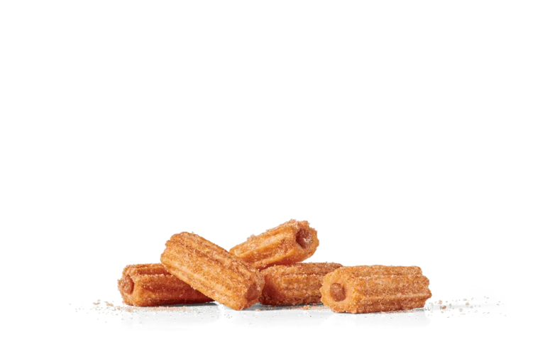 A pile of golden brown mini churros sprinkled with granulated sugar, displayed on transparent background. The churros have a crispy texture and are dusted evenly with sugar, highlighting their traditional ridged surface and tempting appeal.