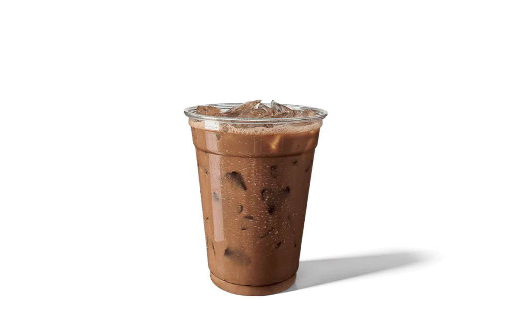 A refreshing cup of Mocha Sweet Cream Iced Coffee served in a clear plastic cup, showcasing a rich chocolate-brown coffee blended with sweet cream and filled with ice cubes. The cup is covered with a transparent lid and features droplets of condensation, emphasizing its cool and indulgent nature.