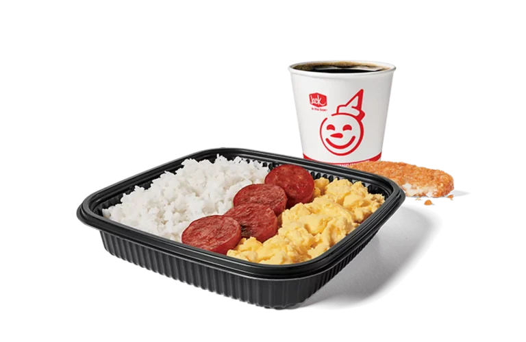 Image of a breakfast platter from Jack in the Box featuring slices of Portuguese sausage alongside a serving of white rice and scrambled eggs. The meal is complemented by a hash brown and a coffee cup branded with the cheerful Jack in the Box logo. This combo is neatly arranged on a black tray, showcasing a satisfying breakfast option.