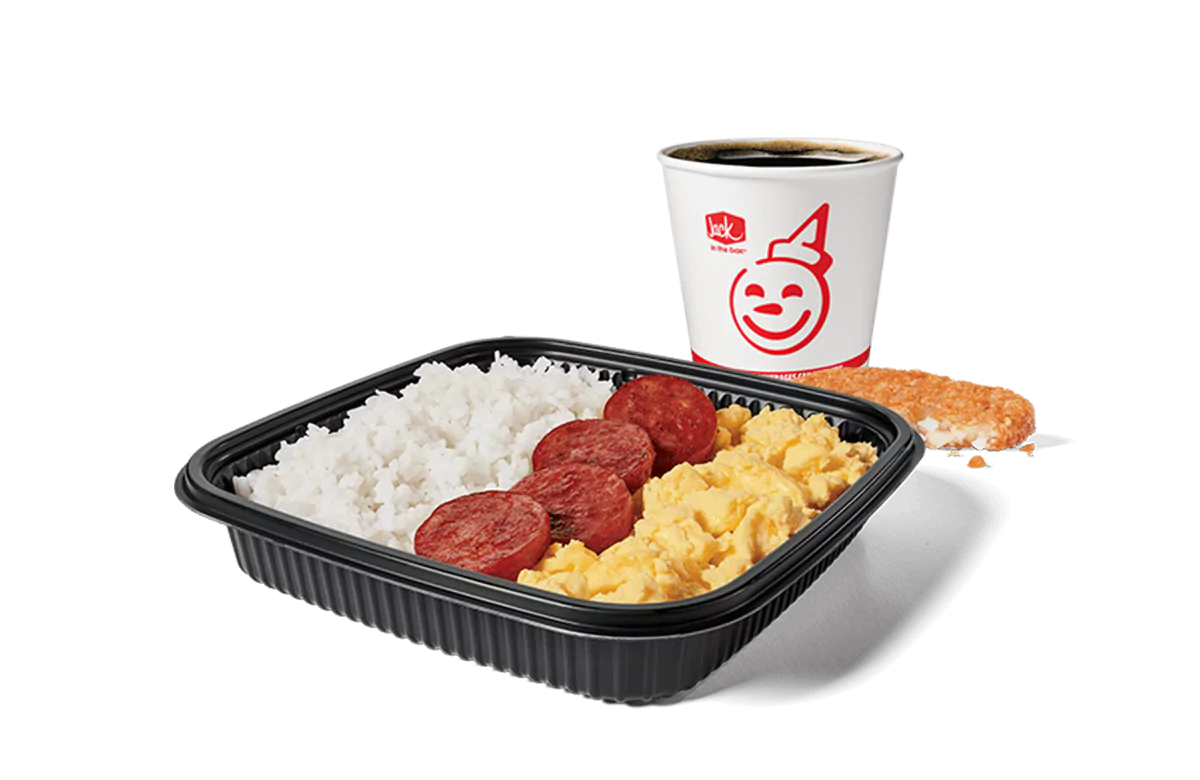 Image of a breakfast platter from Jack in the Box featuring slices of Portuguese sausage alongside a serving of white rice and scrambled eggs. The meal is complemented by a hash brown and a coffee cup branded with the cheerful Jack in the Box logo. This combo is neatly arranged on a black tray, showcasing a satisfying breakfast option.