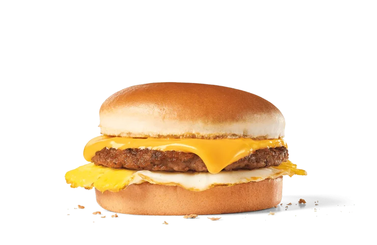 Image of a Sausage Breakfast Jack® sandwich, featuring a juicy sausage patty topped with a fried egg and two slices of melty American cheese, enclosed within a soft, golden hamburger bun.