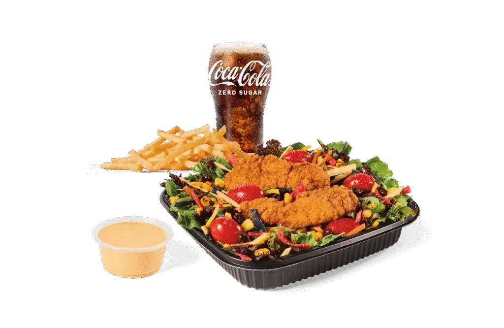 A delicious Southwest Salad topped with crispy chicken strips, served with a side of French fries, a dipping sauce, and a chilled Coca-Cola Zero Sugar drink.