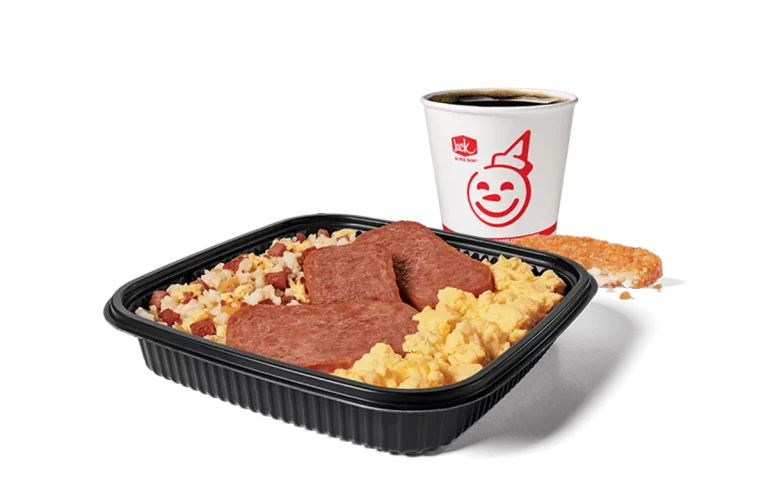 Image showcasing a Jack in the Box combo meal with a platter filled with fried rice, slices of Spam, and scrambled eggs. This set is complemented by a hash brown and a coffee cup with the restaurant's iconic smiling logo. The meal is served on a dark, rectangular tray, emphasizing the hearty breakfast choice.