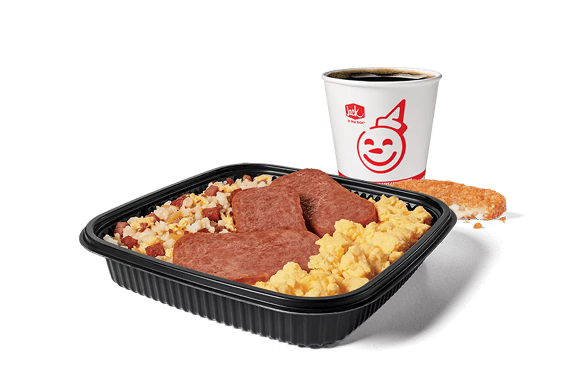 Image showcasing a Jack in the Box combo meal with a platter filled with fried rice, slices of Spam, and scrambled eggs. This set is complemented by a hash brown and a coffee cup with the restaurant's iconic smiling logo. The meal is served on a dark, rectangular tray, emphasizing the hearty breakfast choice.