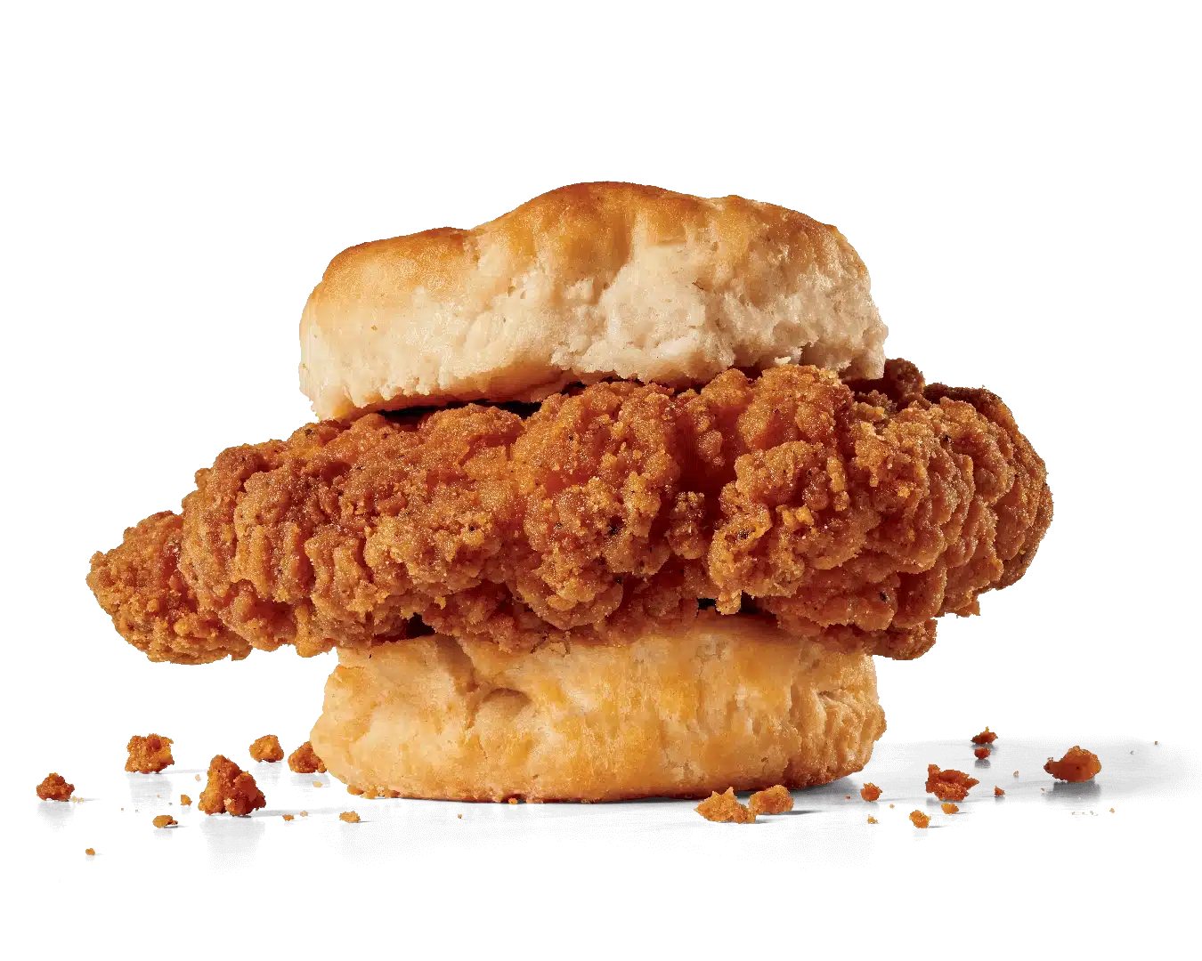 Image of a Spicy Chicken Biscuit showcasing two crispy chicken tenders with a spicy breading, nestled inside a soft, flaky biscuit, with crispy crumbs scattered around, emphasizing the texture and spice of the chicken.