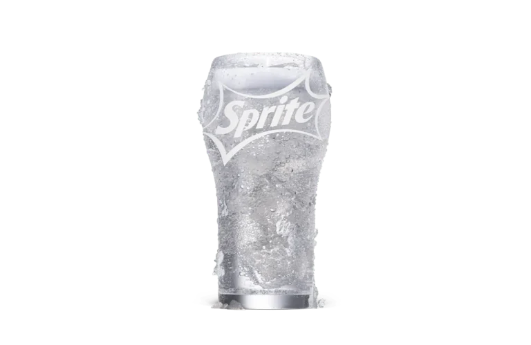 A refreshing glass of Sprite® served over ice in a transparent glass with the Sprite logo prominently displayed. The drink appears crisp and bubbly, highlighting its fizzy and thirst-quenching nature. Droplets of condensation on the glass emphasize its chilled state.