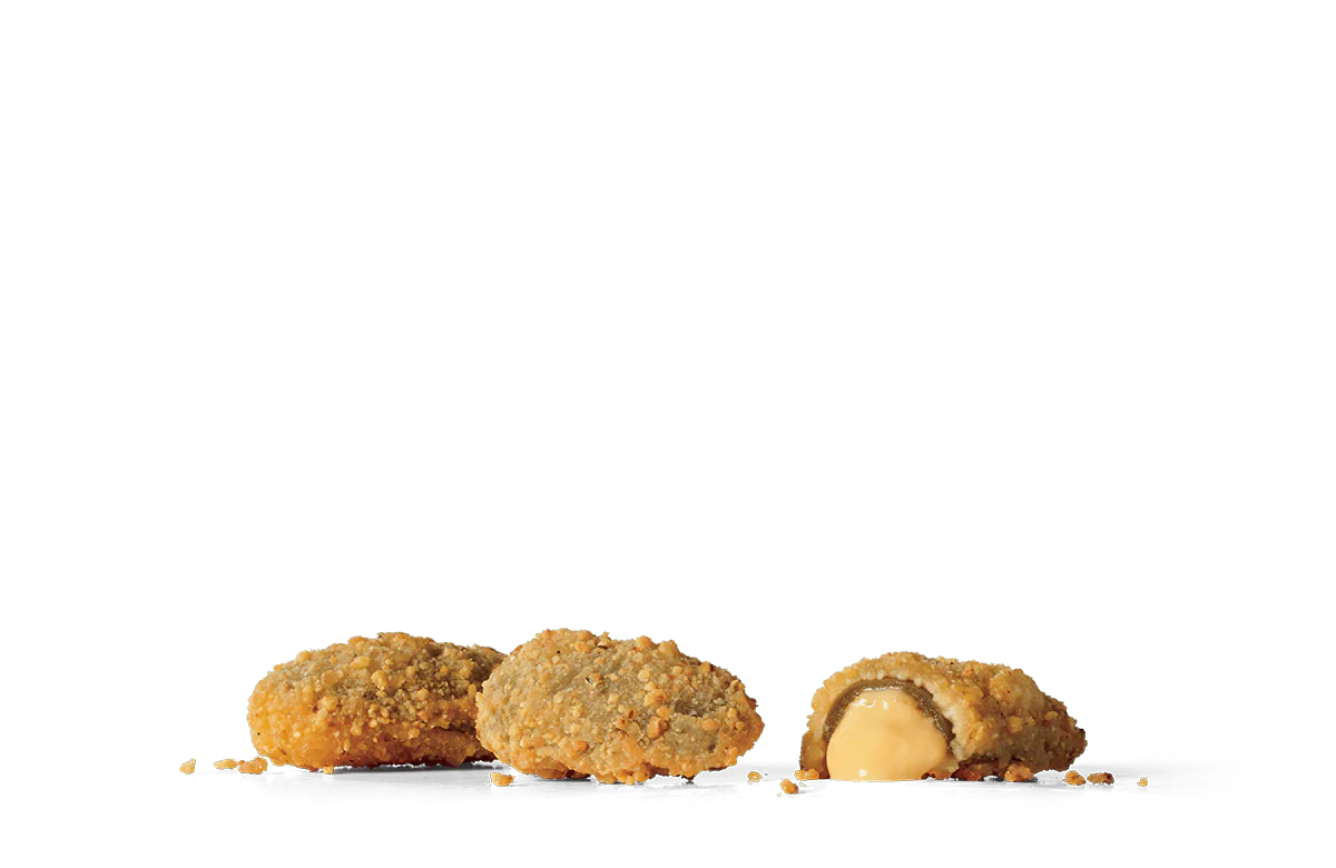 Several golden-brown crispy stuffed jalapeños on transparent background. One jalapeño is sliced open, showcasing a gooey cheese center, with crumbs scattered around the jalapeños. The breadcrumb coating on the jalapeños provides a textured appearance.