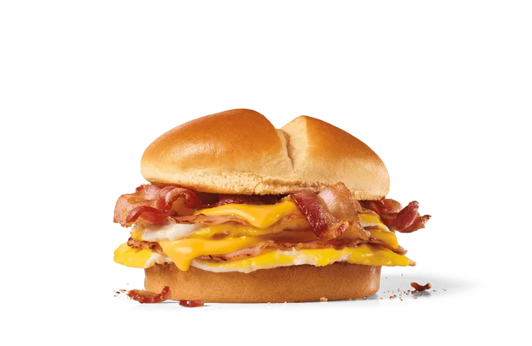 A close-up image of a delicious breakfast sandwich with crispy bacon, melted cheese, and a fresh egg, all nestled between soft sandwich buns.