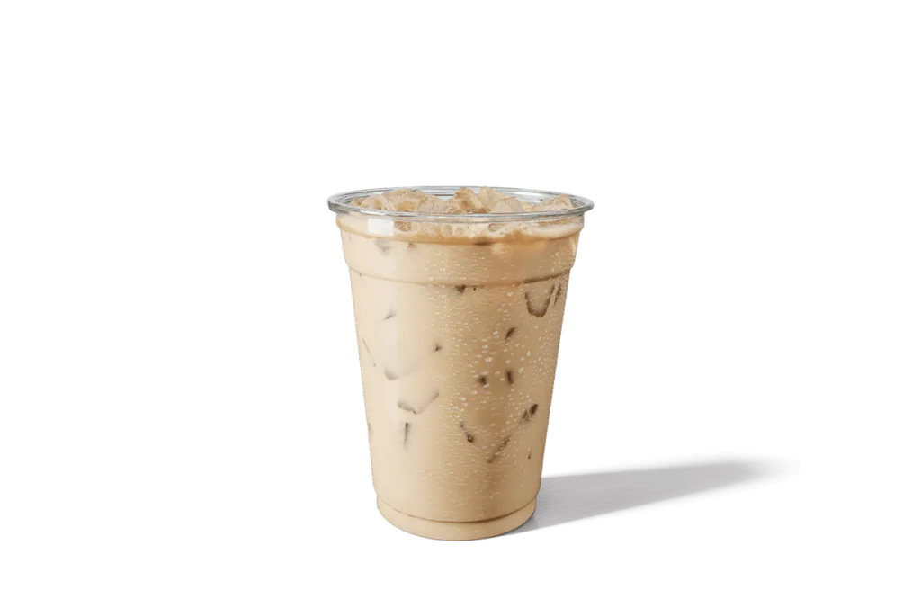A chilled cup of Vanilla Sweet Cream Iced Coffee served in a transparent cup, featuring light tan coffee mixed with creamy vanilla and filled with ice cubes. The cup is sealed with a clear lid, with condensation droplets on the outer surface, highlighting its refreshing and smooth flavor.