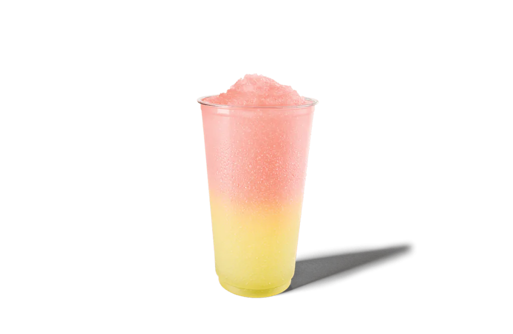 A clear cup filled with a vibrant watermelon lemonade swirl slushie. The drink features a gradient from yellow at the bottom to pink at the top, with a textured icy appearance, making it a perfect summer refreshment.